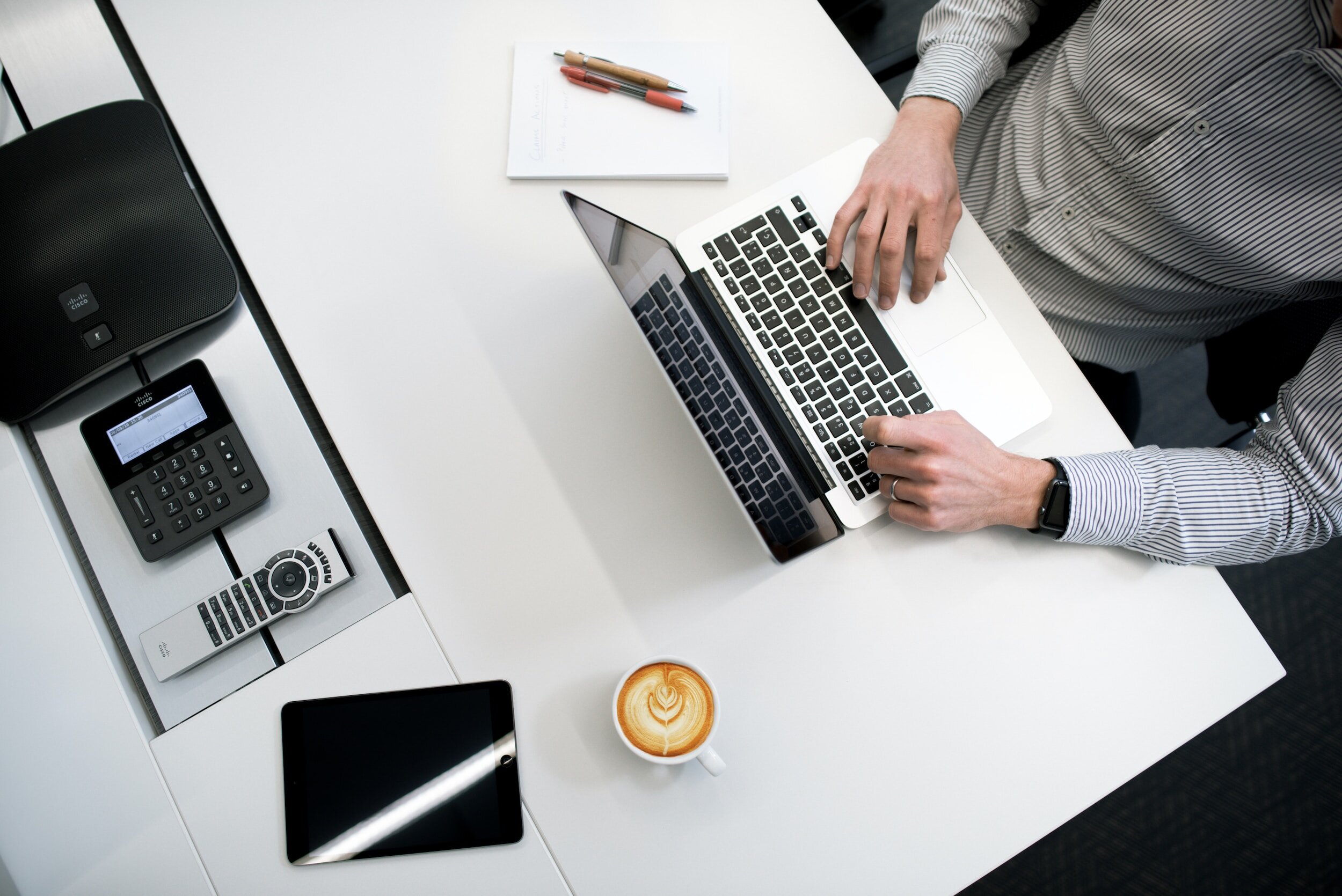 Accountant reviewing client notes at a desk with a laptop
